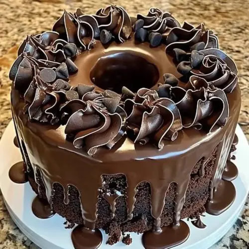 Decadent death by chocolate cake served on a plate with chocolate drizzle