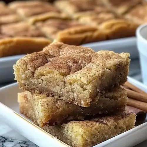 Delicious soft and chewy snickerdoodle bars on a white plate